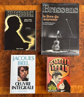 three books are sitting on a table next to each other
