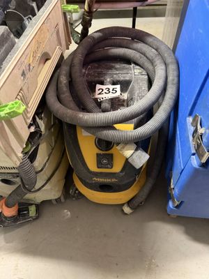a vacuum that is sitting next to a blue box