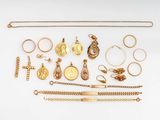 an assortment of gold jewelry including a cross, bracelets, and rings