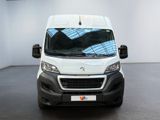 the white van is parked in a white room with a black floor