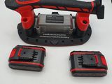 a close up of a cordless drill and two batteries