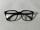 a pair of glasses sitting on top of a white surface