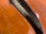 a close up of a person ' s feet and a guitar