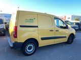 the yellow van is parked in a parking lot with other cars