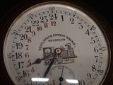 a close up of a clock with a train on it