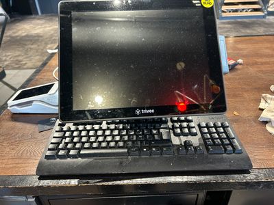 a laptop computer sitting on top of a wooden table