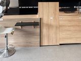 a desk with a chair and a cabinet in the room