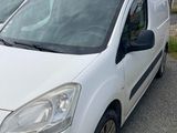 two white vans parked next to each other in a parking lot
