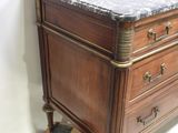 a marble top chest of drawers with a marble top
