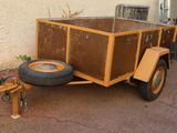 a small trailer with a trailer attached to it