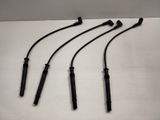a set of four black electrodes sitting on top of a white surface