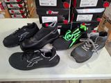 several pairs of shoes are on a table in front of boxes