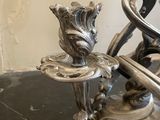 a silver candle holder on a marble counter top