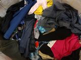 a pile of clothes sitting on the floor in the room