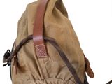 a tan backpack with a brown leather strap on it
