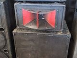 three speakers stacked on top of each other in a room
