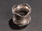 a silver ring that is sitting on top of a table