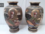two vases that are sitting on a table