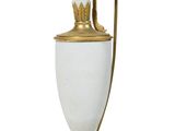 a white and gold vase with a bird on it