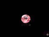 a pink diamond on a black background