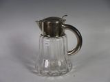 a small glass pitcher with a silver lid