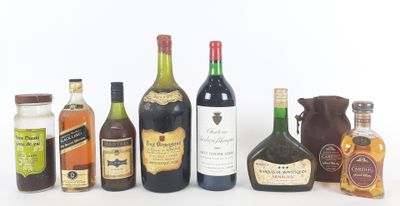 several bottles of liquor are lined up on a white surface