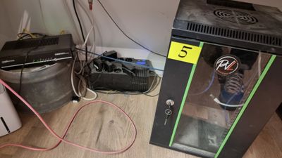 a small refrigerator with a soda can in it on the floor