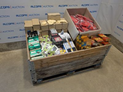 a wooden box filled with assorted items in front of a wall