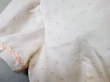 a close up of a white shirt with pink polka dots on it