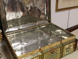a silver box sitting on a table next to a mirror