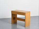 a small wooden bench in the middle of a room