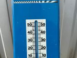 a thermometer that is on the side of a building