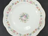 a white plate with flowers on it on a table