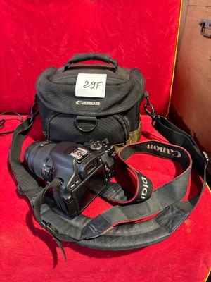 a close up of a camera and a camera bag on a red chair