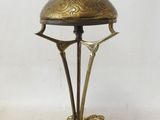 an image of a brass lamp with a bird on it