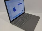 an open laptop computer sitting on top of a white table