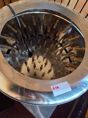 a metal strainer that is sitting on top of a table