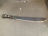 a knife that is laying on a table next to a bottle