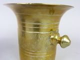 a brass vase with a handle on a white background