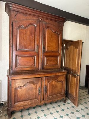 a large wooden cabinet in the corner of a room