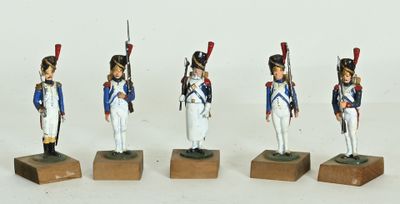 four figurines of soldiers in uniform standing on wooden bases