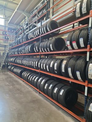 a bunch of tires are stacked on a rack in a warehouse