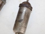 two old metal items that are on a table