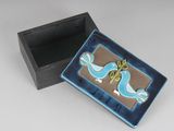 a small blue box with a bird design on it