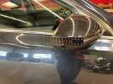 a reflection of a man in the mirror of a car