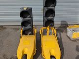 two traffic lights sitting next to each other in front of a garage
