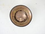 a small metal object on a white surface