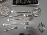 a lot of silver spoons and spoon spoons on a table