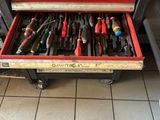 many tools in the drawer of a workbench