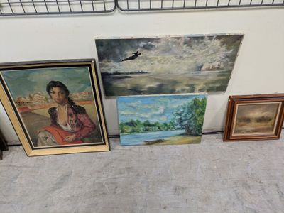 many paintings on the wall next to each other